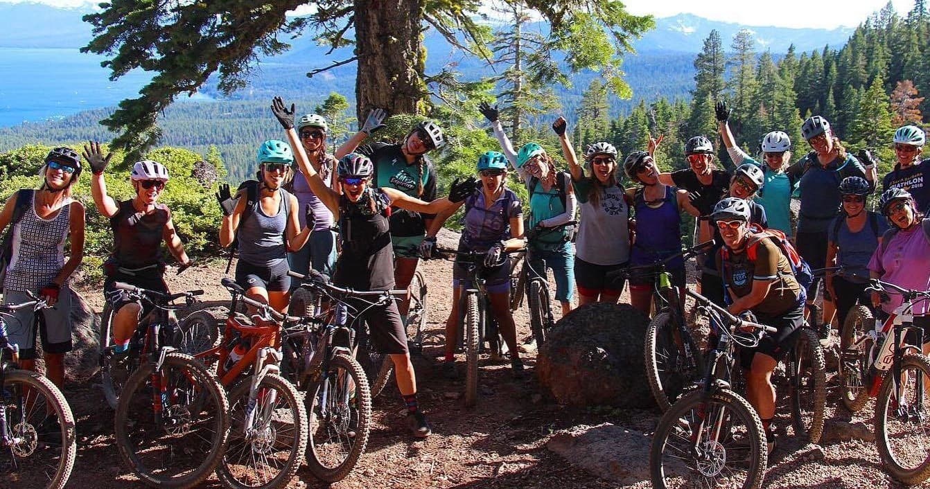 Large guided mountain bike group on Tahoe forest trail gathering