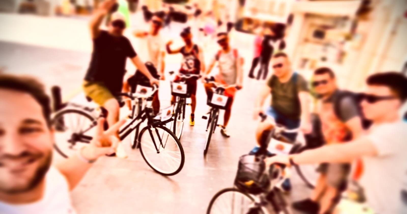 Group bike tour cycling through sunny urban Valencia streets