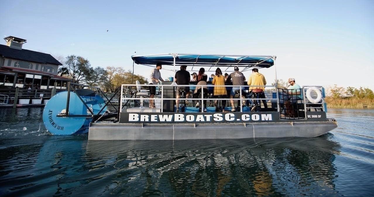 Brew boat cruising on calm North Carolina river with passengers