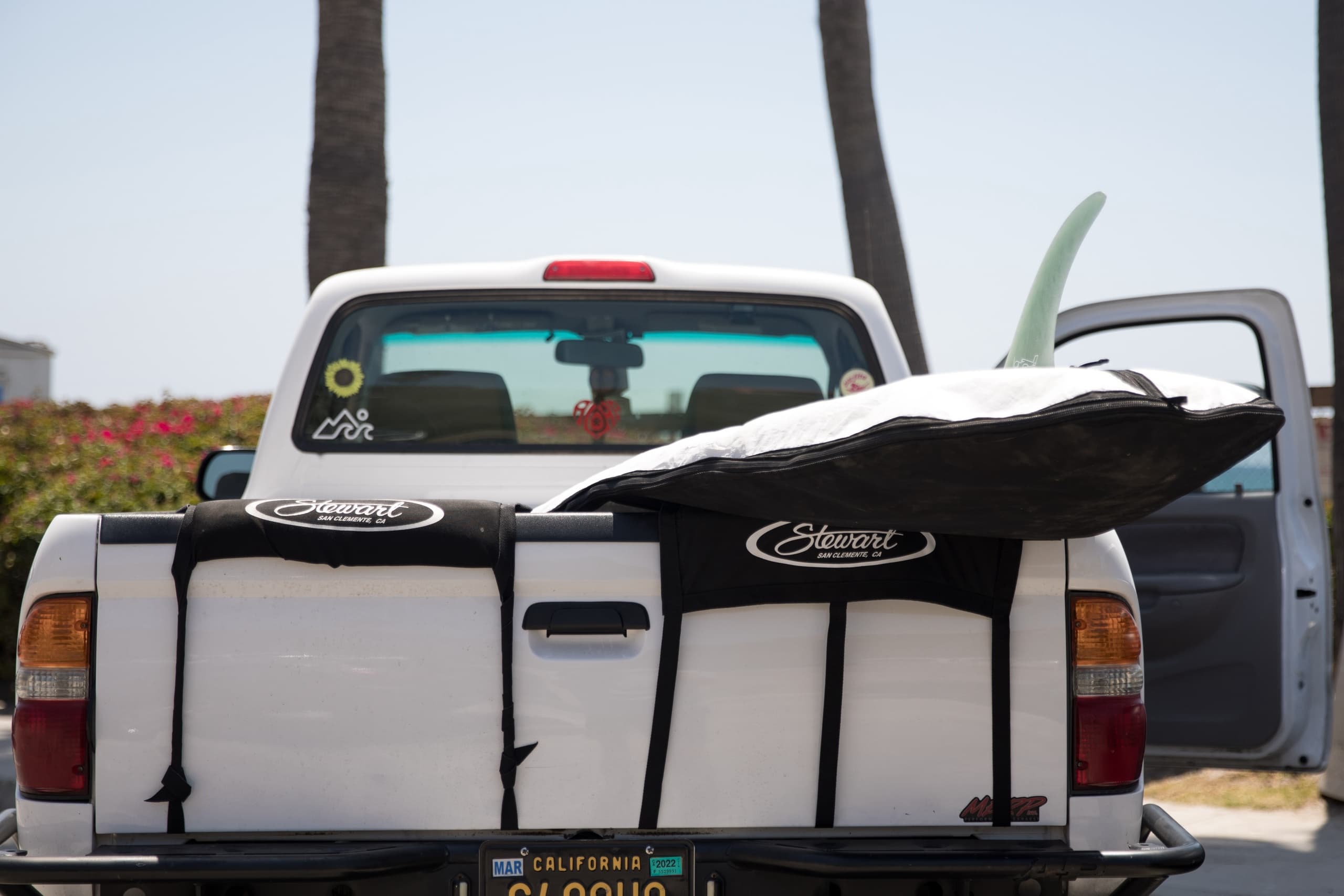 Pickup truck with surfboards at beach parking, ready to surf