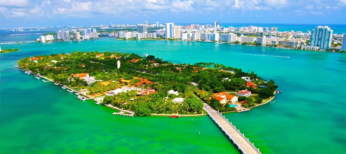 Aerial view of tropical island with turquoise waters and bridge