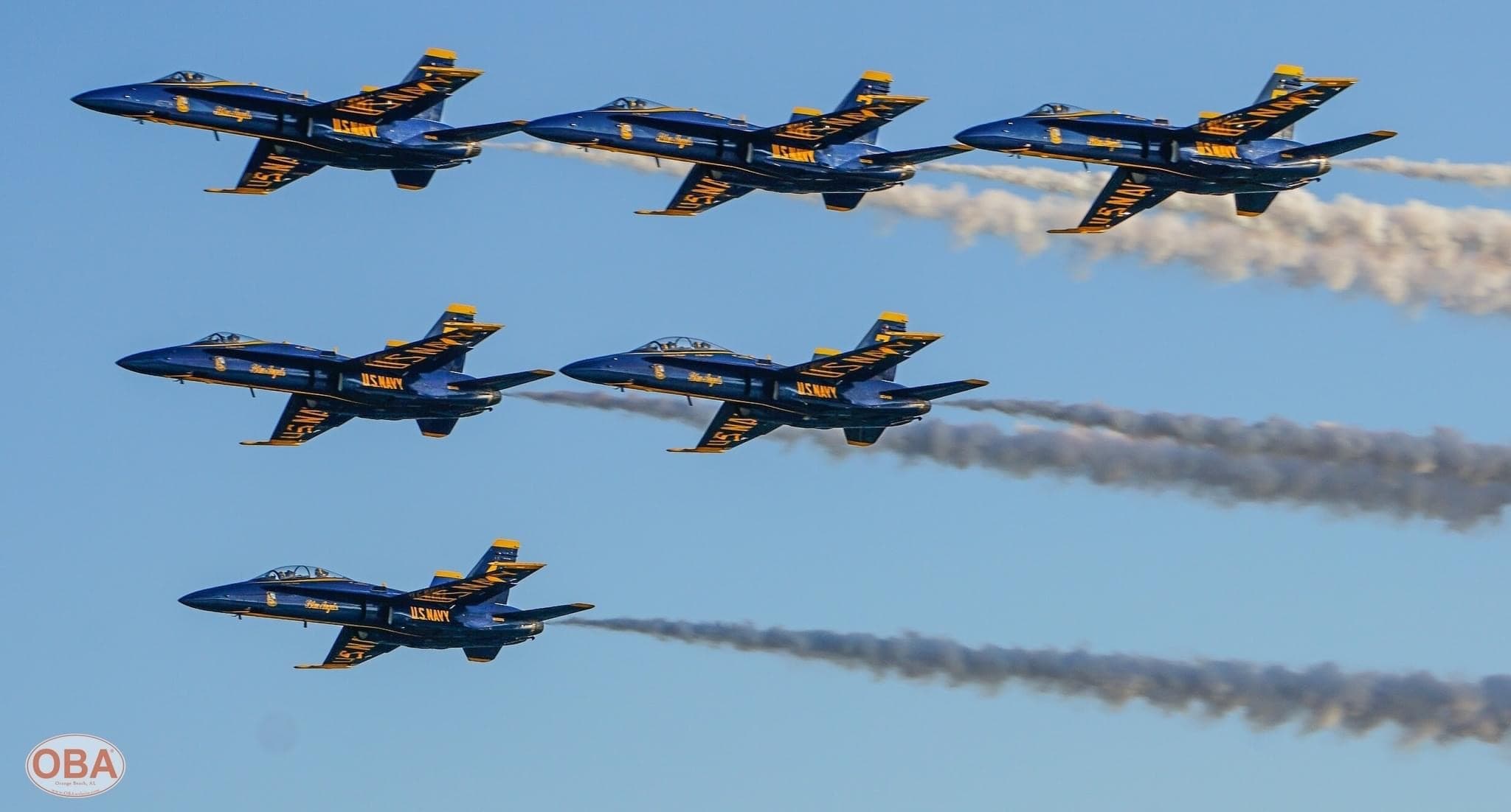 Blue Angels jets flying tight formation, airshow over clear sky