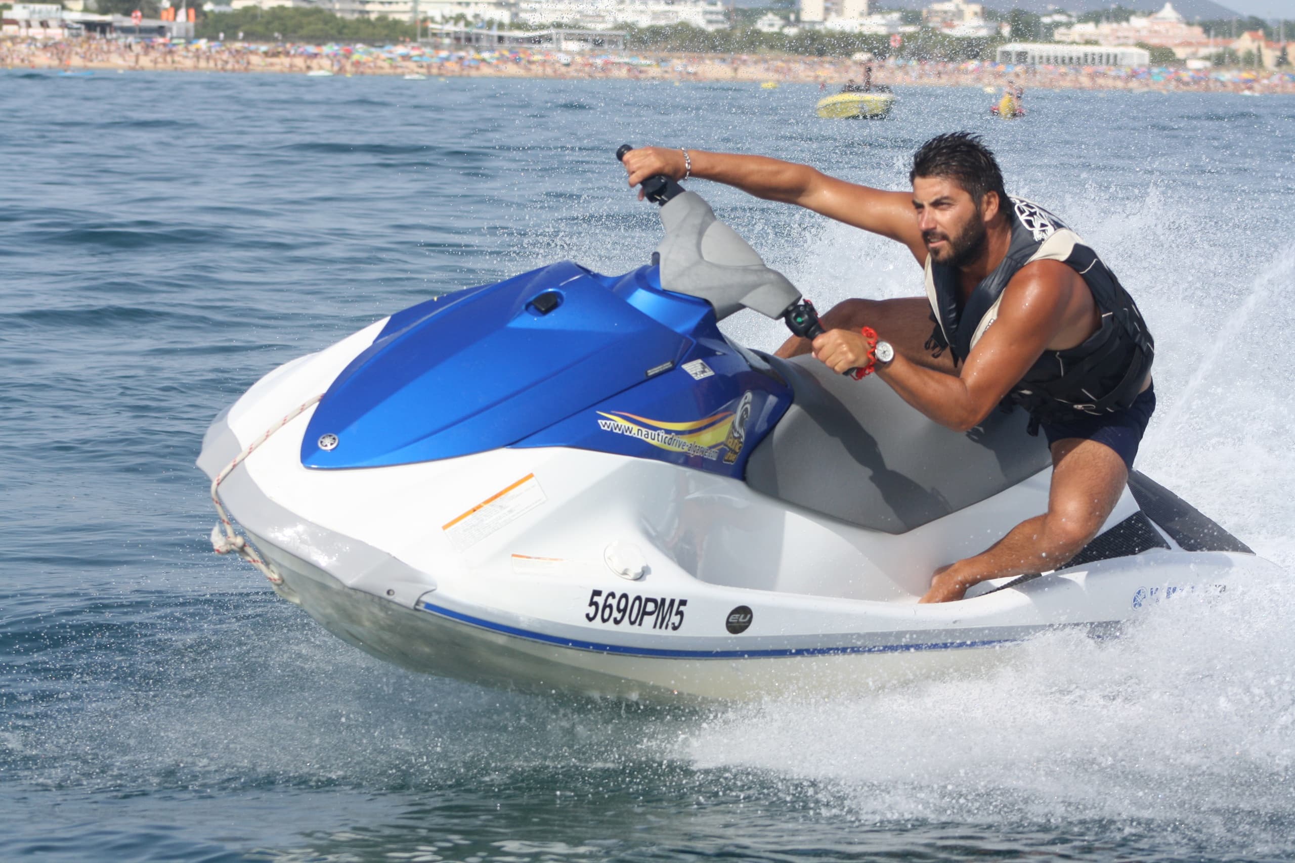 Solo jet ski rider carving through choppy open ocean spray