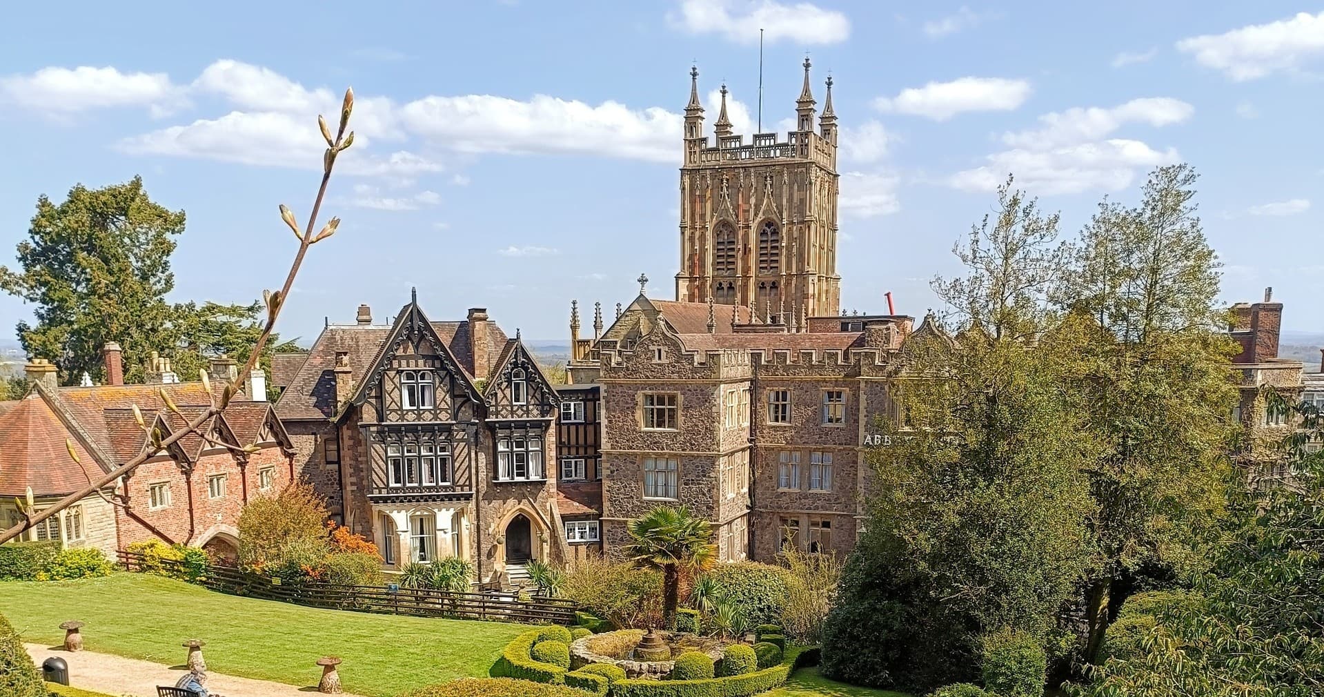 Historic manor and gardens on sunny hilltop, scenic estate view