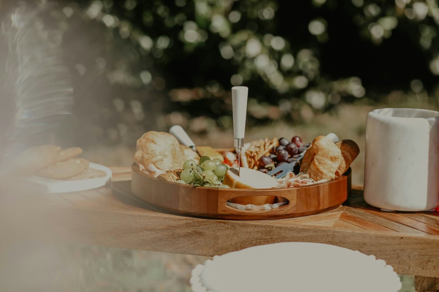 Gourmet picnic charcuterie board on tropical beach table