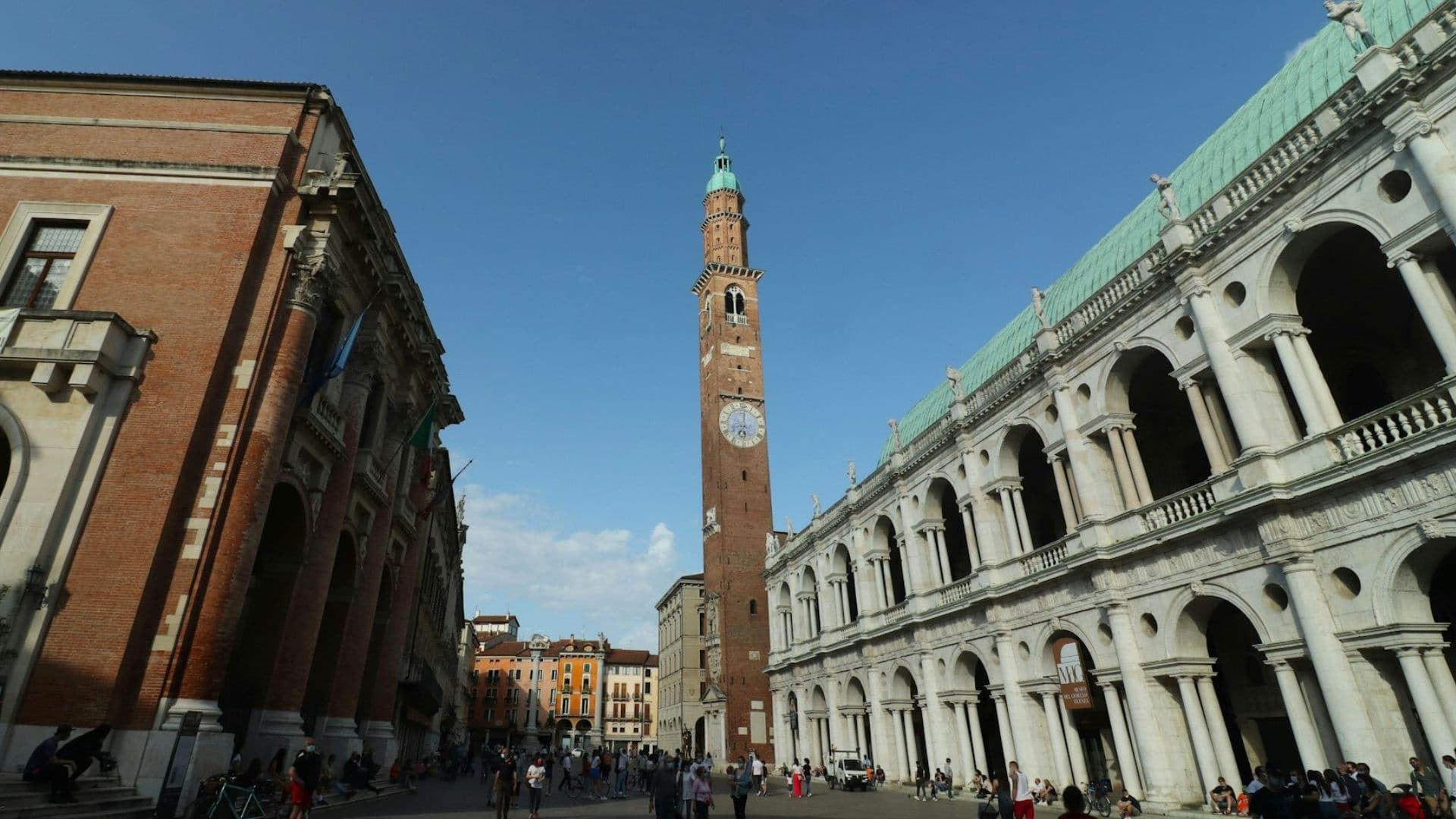 Historic city square with clock tower, urban walking tour