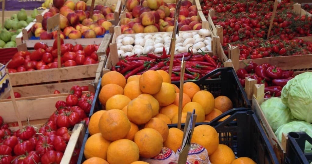 Colorful citrus and produce market stall, open-air Sicilian market