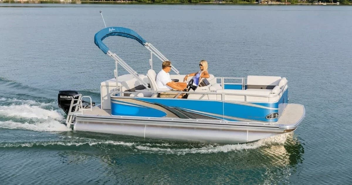 Blue pontoon boat touring tranquil lake with shaded seating