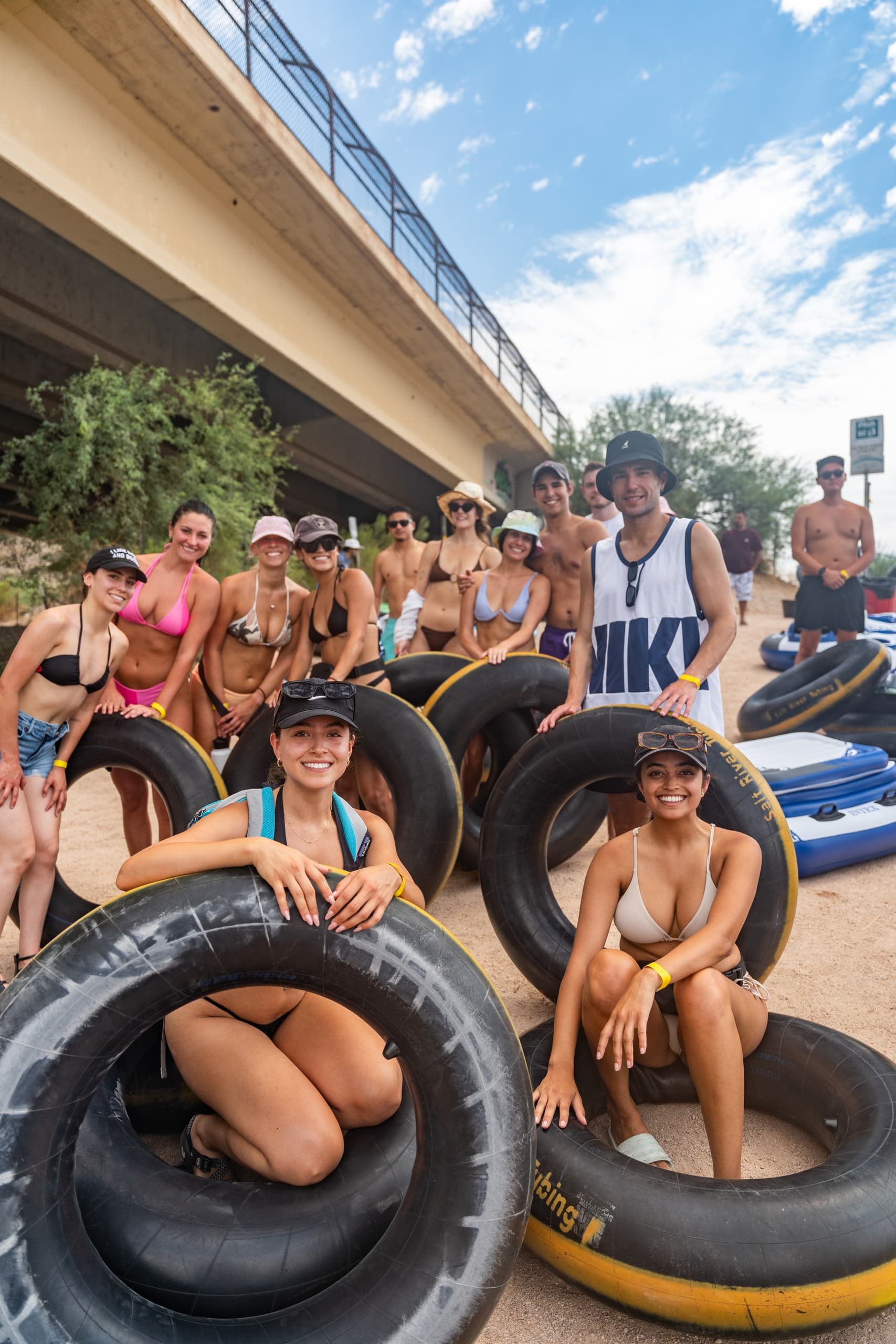Group tubing on Salt River with inner tubes by riverside