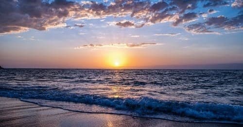 Sunset surf and shoreline waves ideal for beach adventures