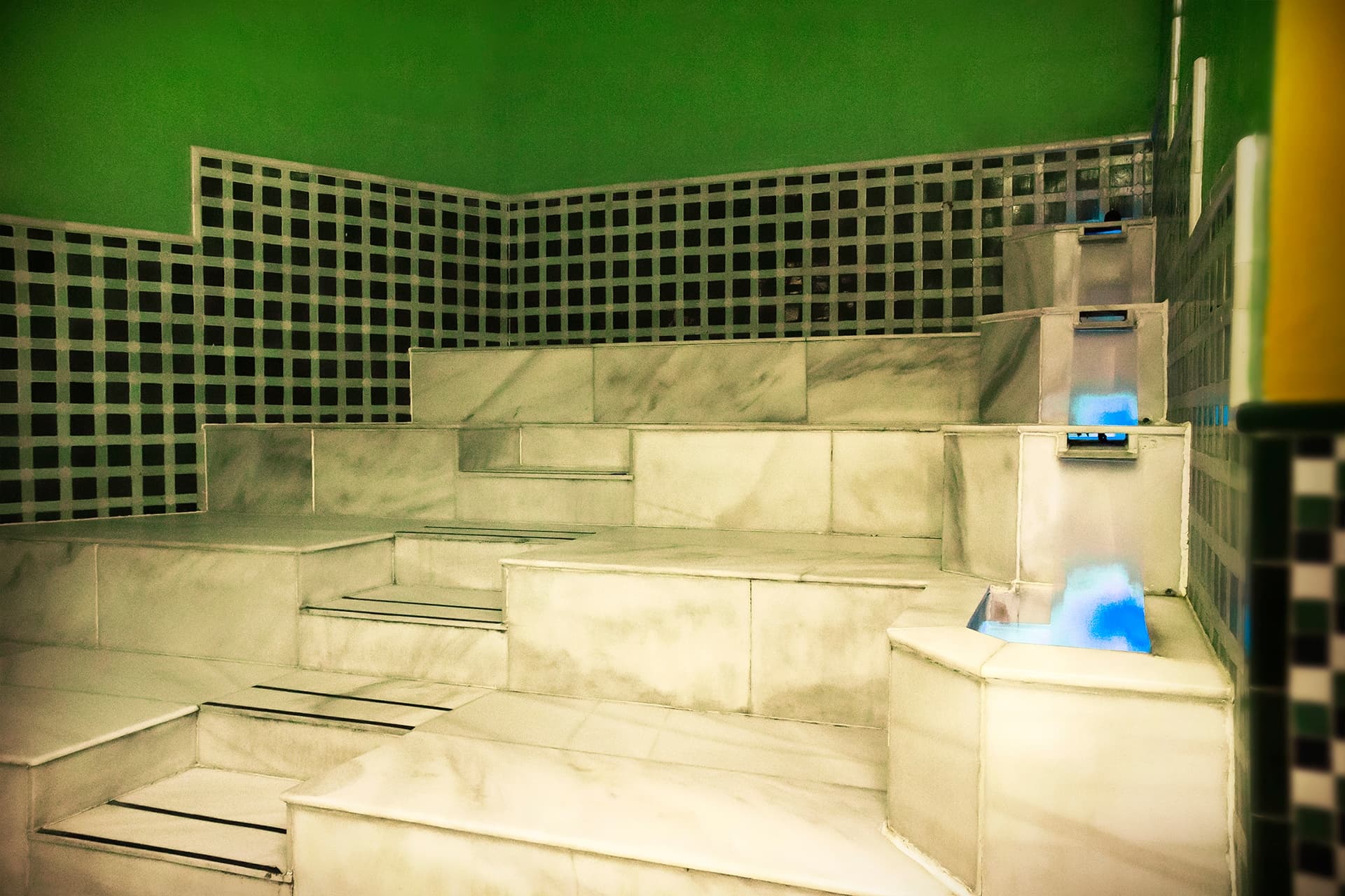 Marble steam room with green lighting in historic hammam interior