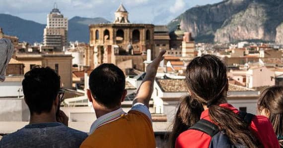 Tourists pointing at Palermo skyline on rooftop walking tour