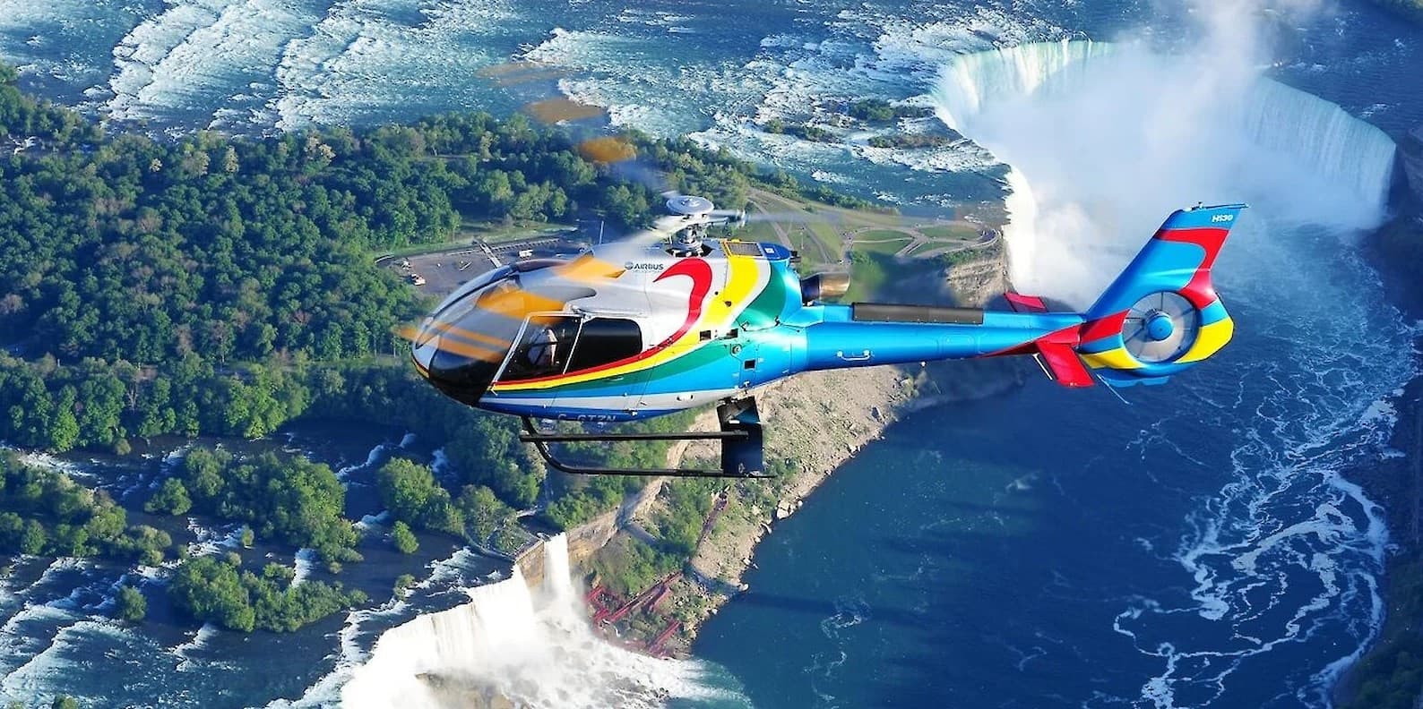 Helicopter touring over Niagara Falls and river gorge