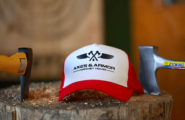 Axes & Armor cap on stump with throwing axes, rustic branding