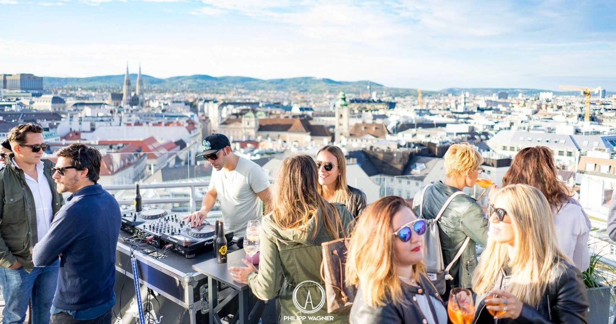Rooftop social group enjoying panoramic city views on tour terrace