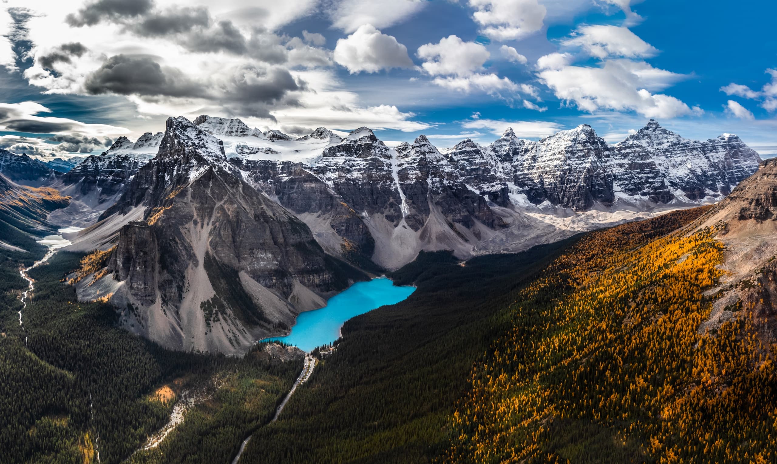 Canoeist paddling turquoise mountain lake at Moraine Lake, Banff