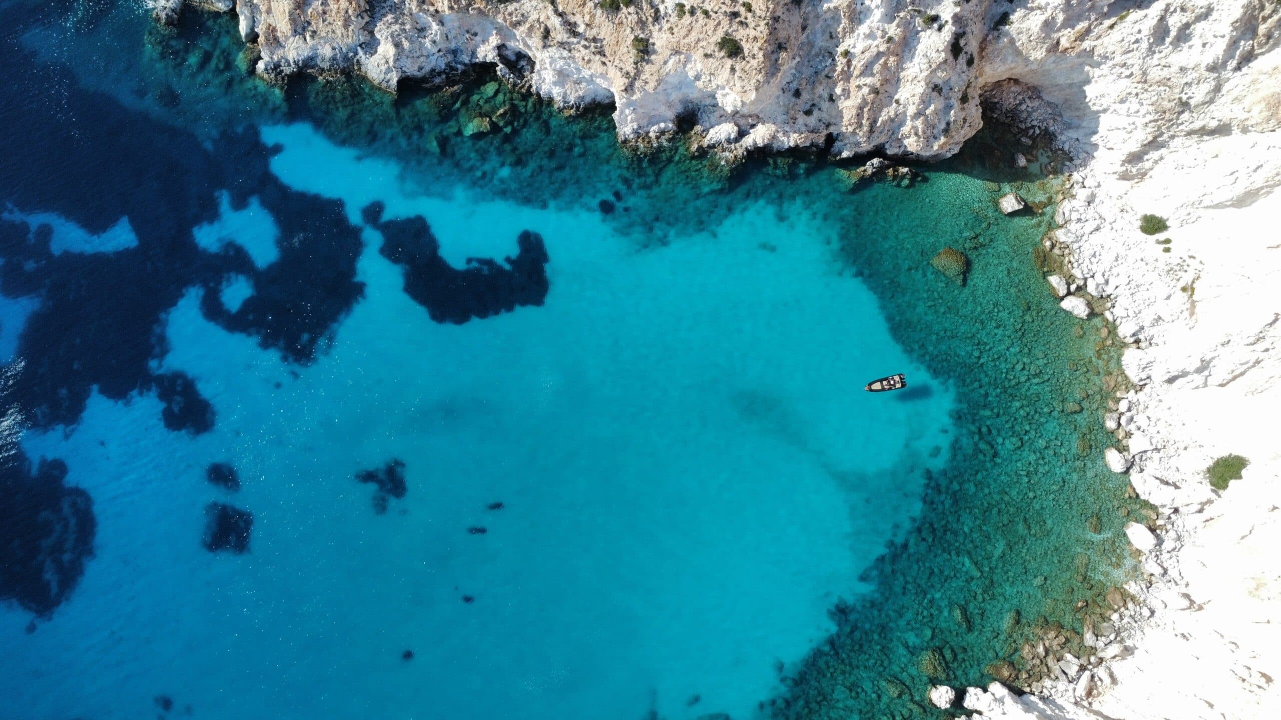Clear turquoise lagoon and reef patterns in coastal aerial shot