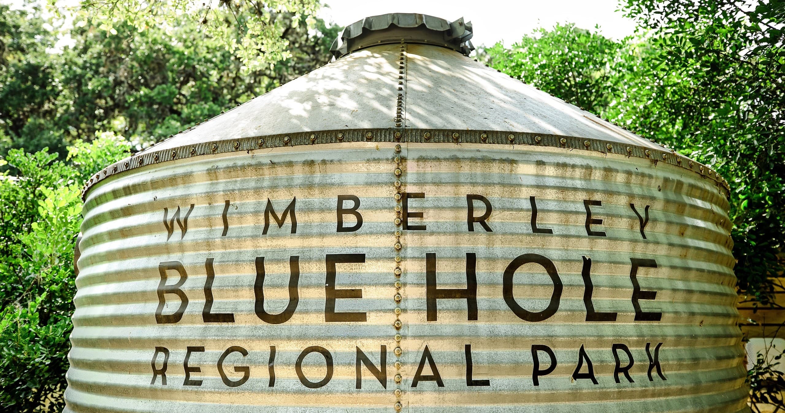 Historic Blue Hole sign at Wimberley regional park entrance