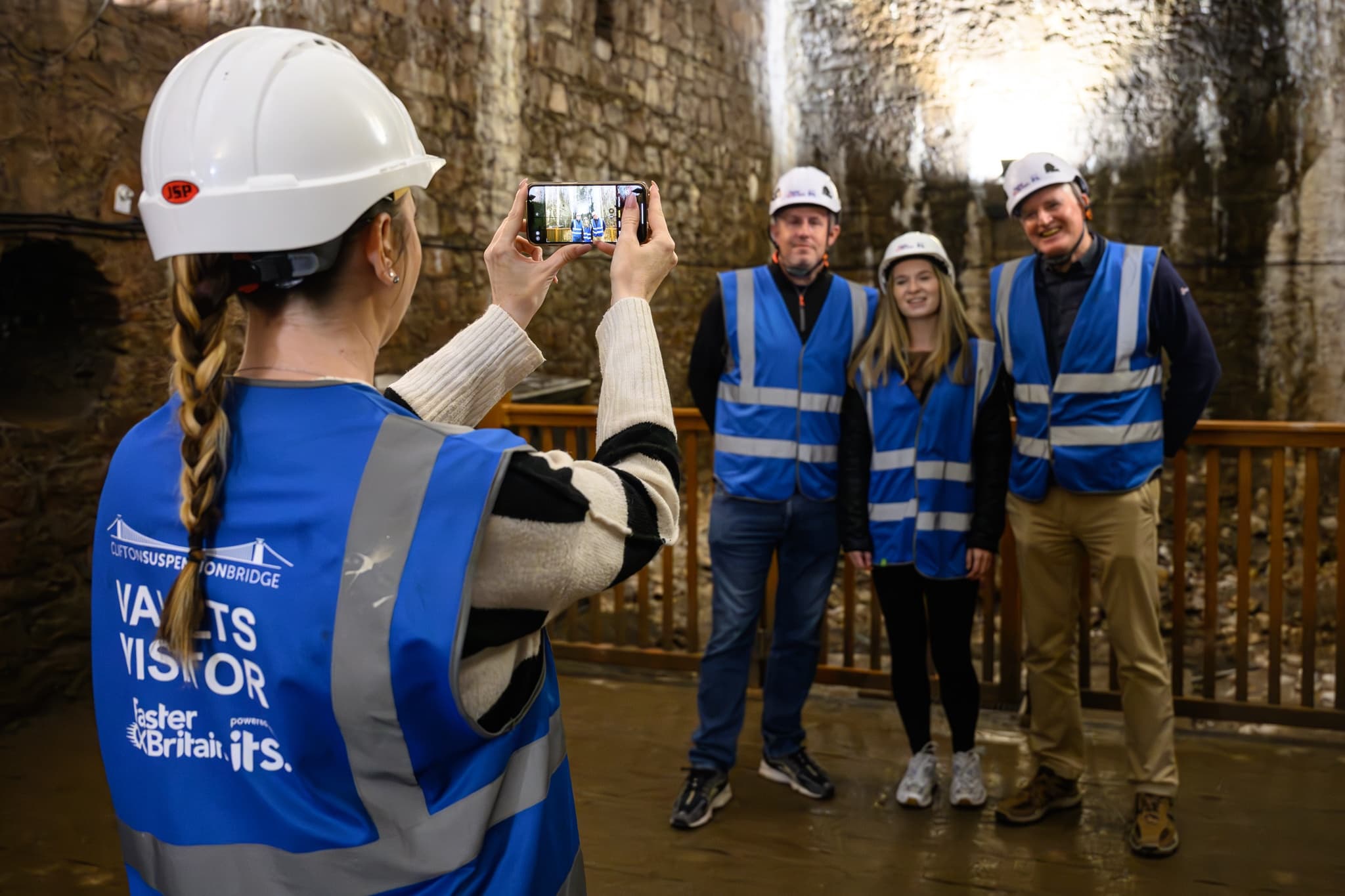 Visitors posing beneath Clifton Bridge arch on guided underground tour