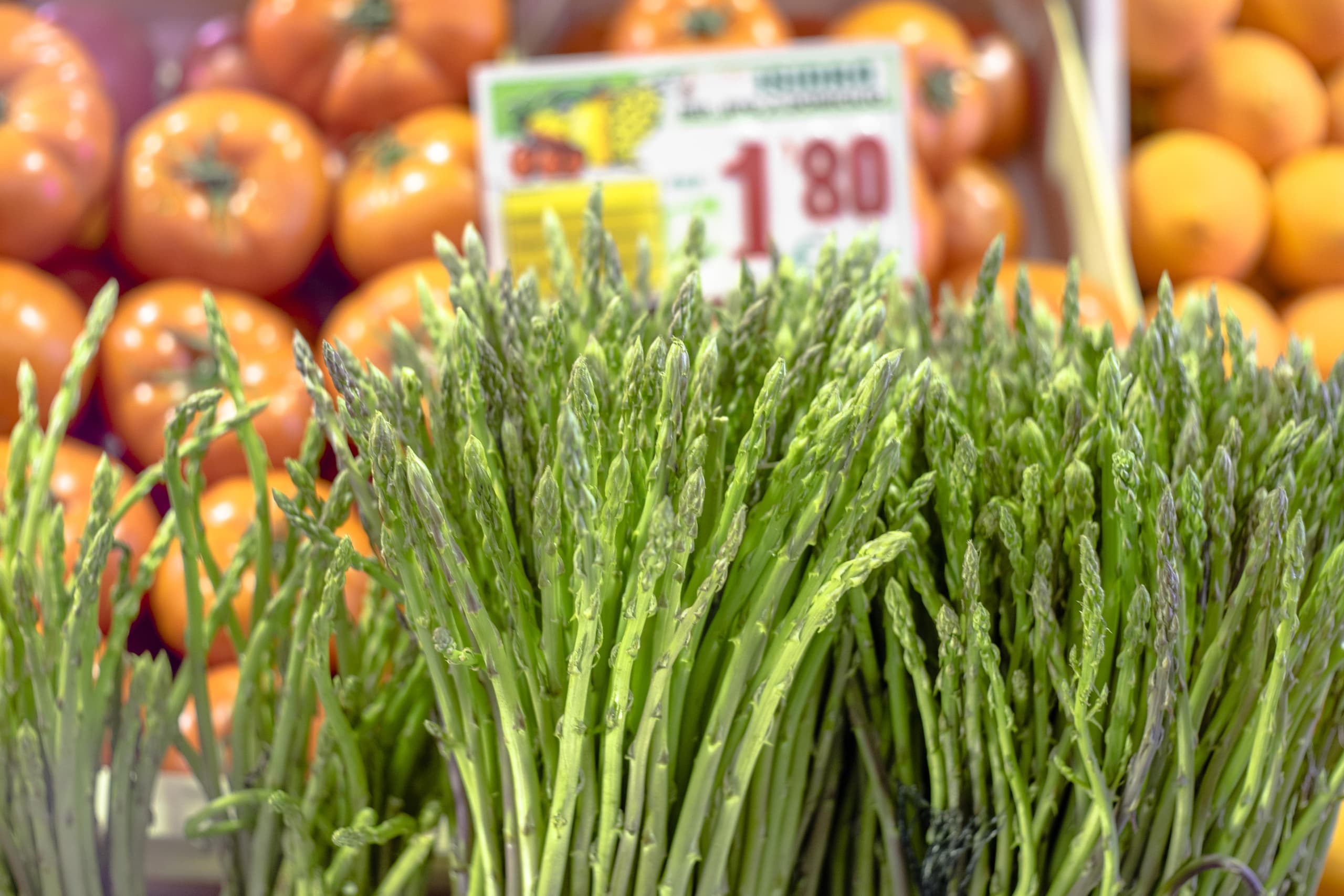 Close-up of fresh asparagus at Málaga market produce stall