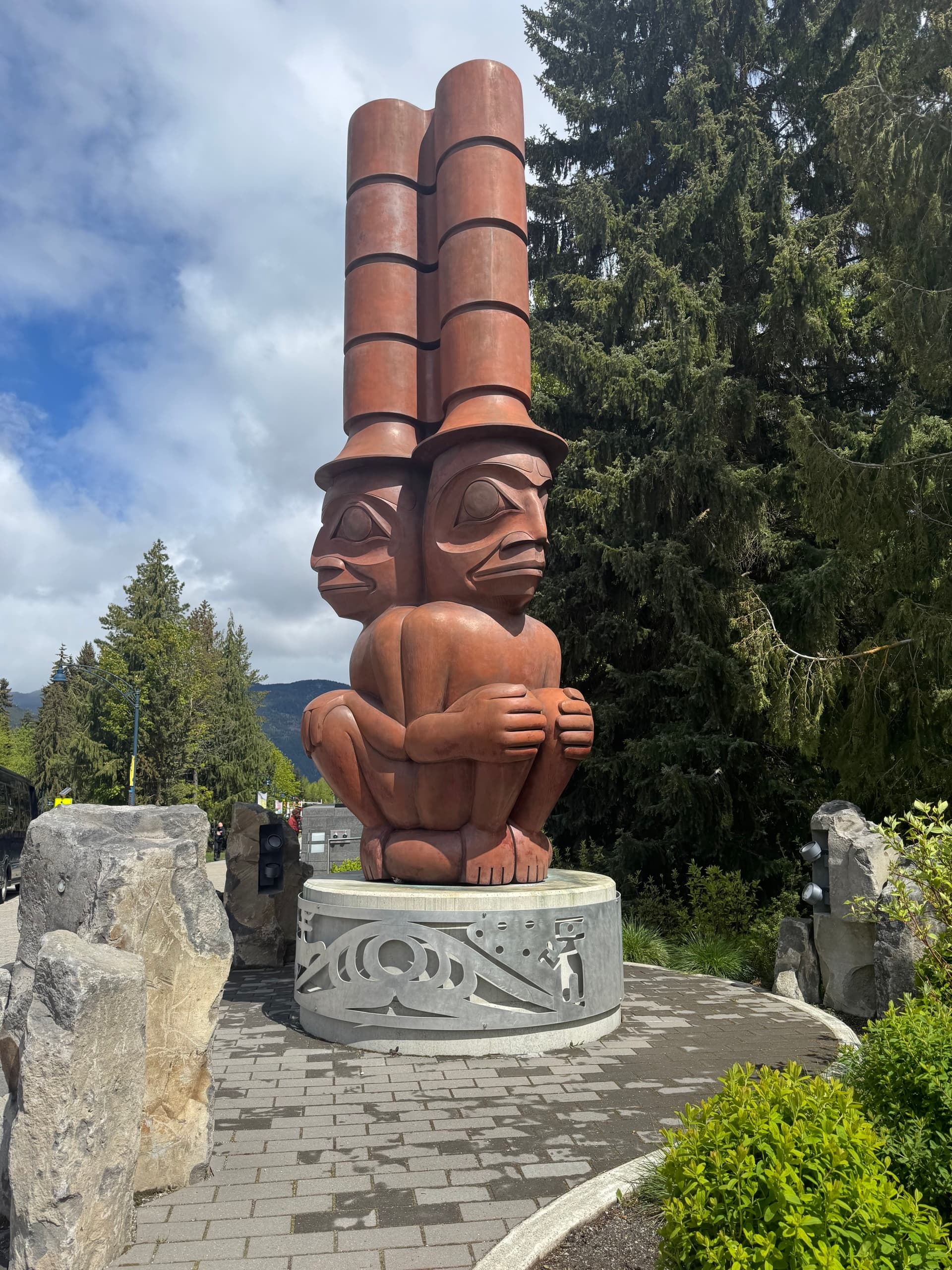 Large carved totem sculpture in park plaza cultural landmark