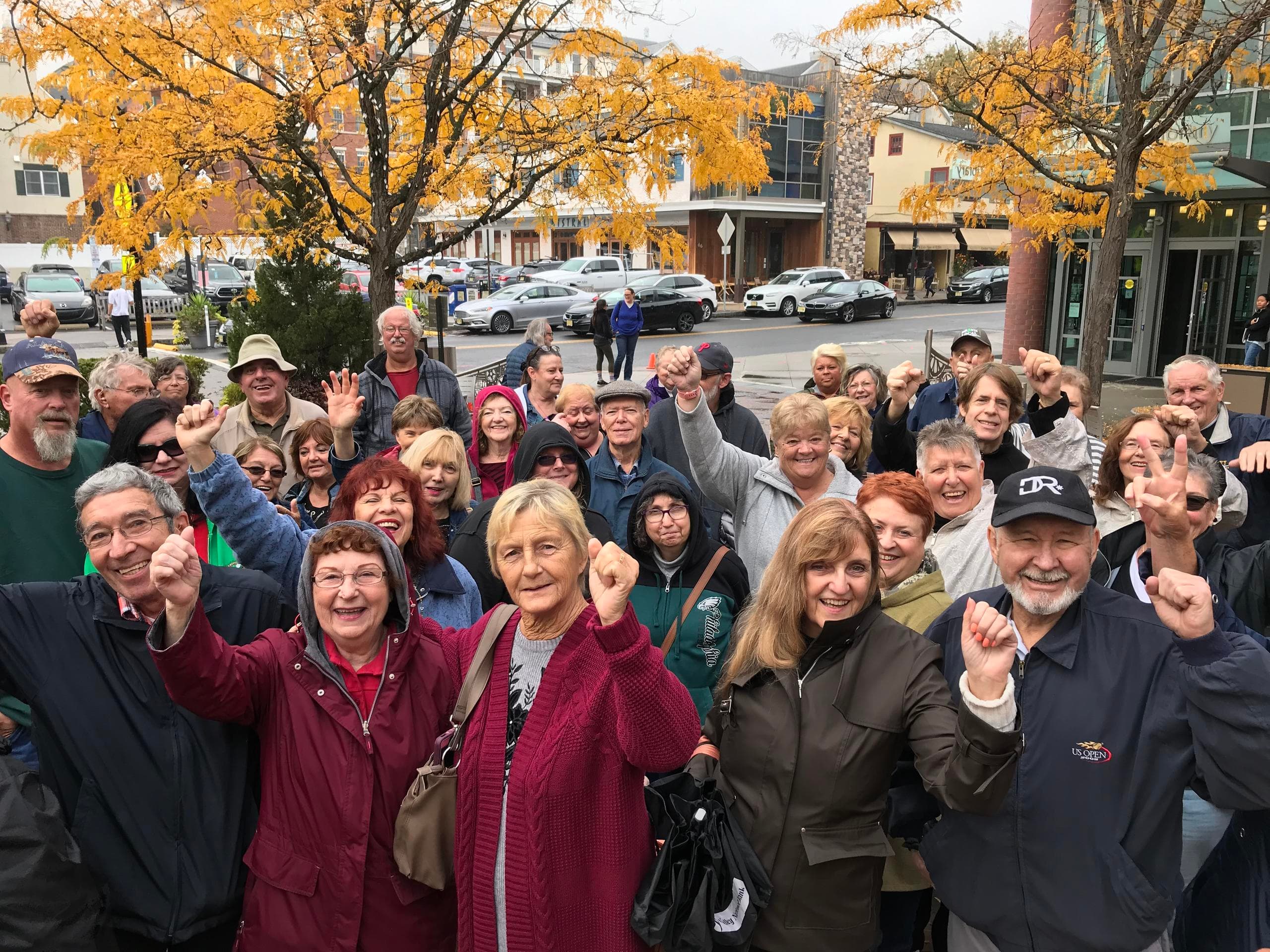 Large outdoor walking tour group in autumn town square