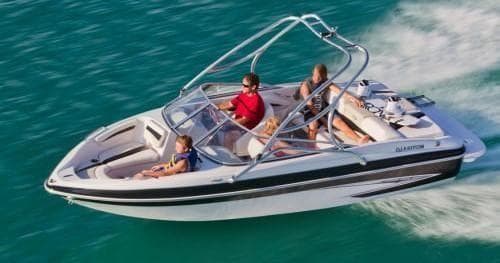 Speedboat cruising turquoise lake with passengers at speed