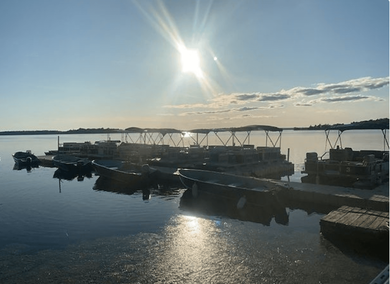 Harbor sunrise with moored boats and calm reflective water