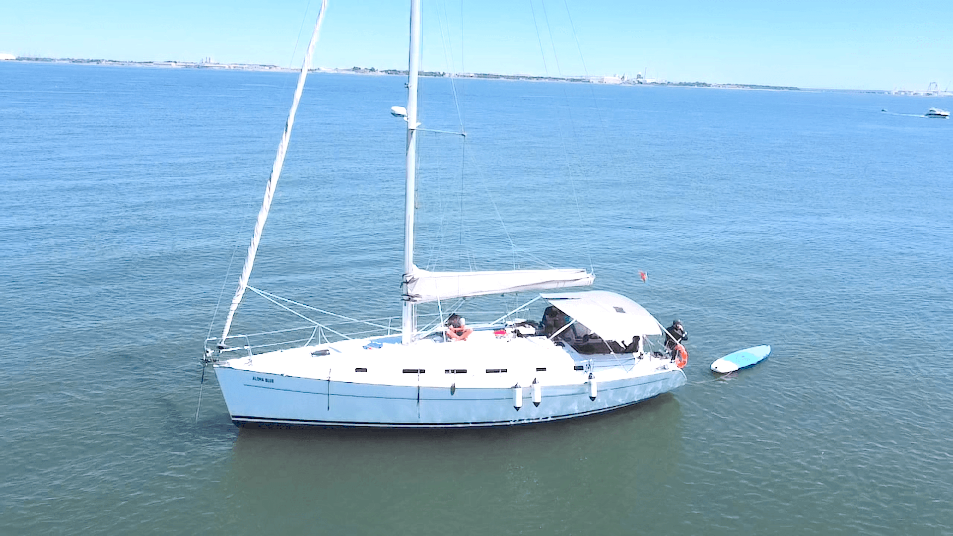 White sailing yacht anchored on calm open sea for day charter