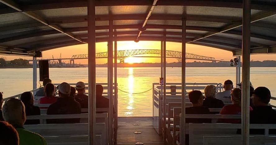 Sunset river cruise passengers silhouetted on open deck in Jacksonville