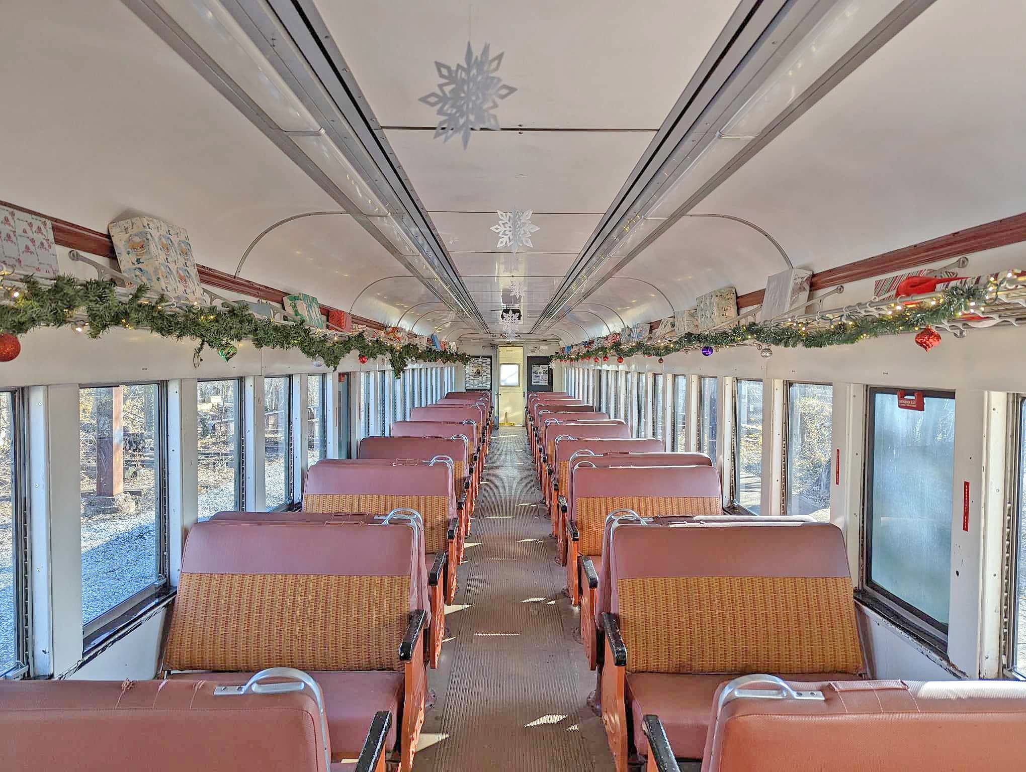 Retro passenger railcar interior with window views for scenic trips