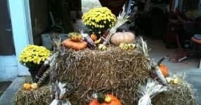 Autumn hay bale display with pumpkins at farm market