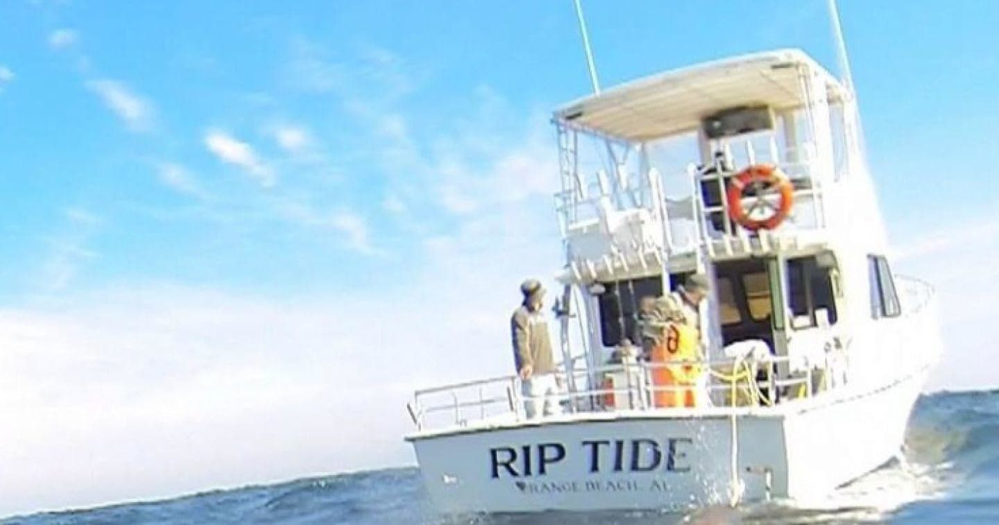 Large sportfishing boat cruising calm coastal waters offshore