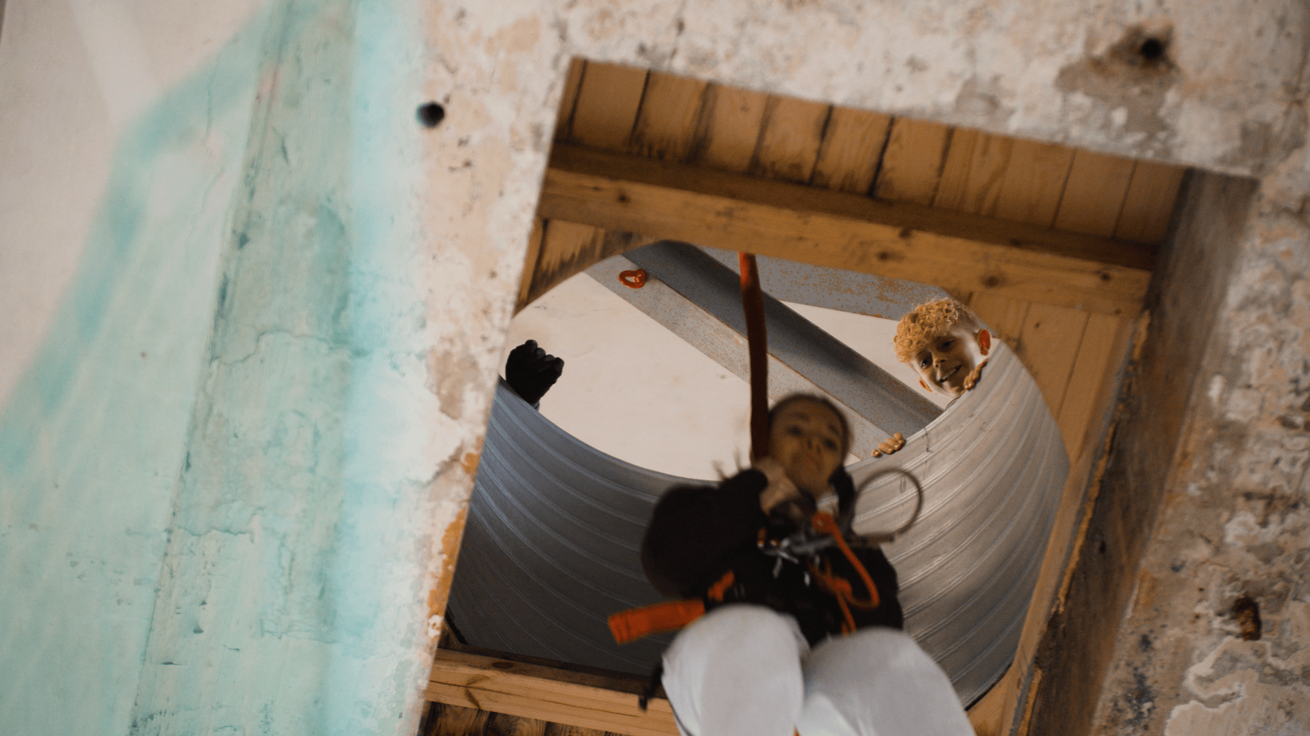 Person descending through indoor climbing structure opening