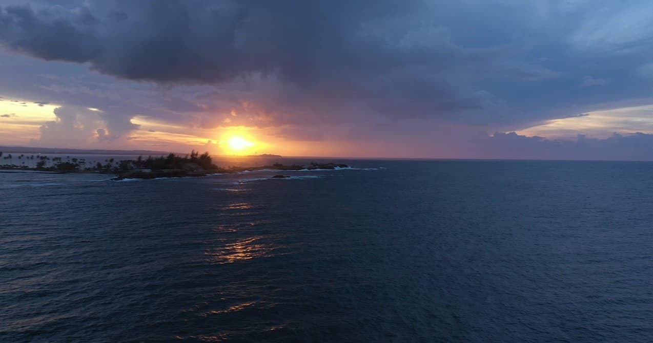 Dramatic ocean sunset with cloudscape over open sea, horizon