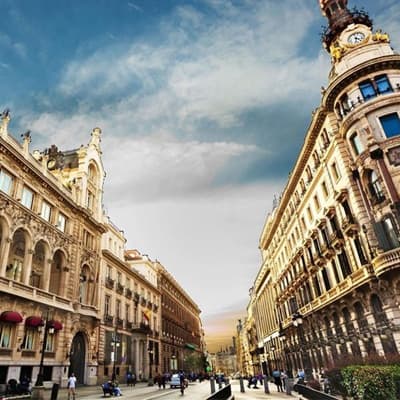 Historic Madrid boulevard with pedestrians and grand architecture