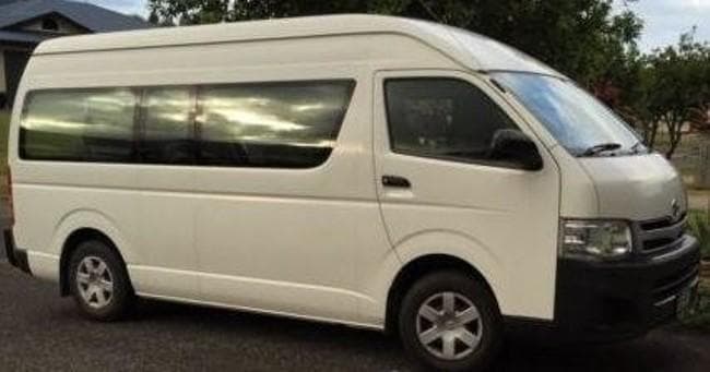 White commuter van ready for airport shuttle on suburban street