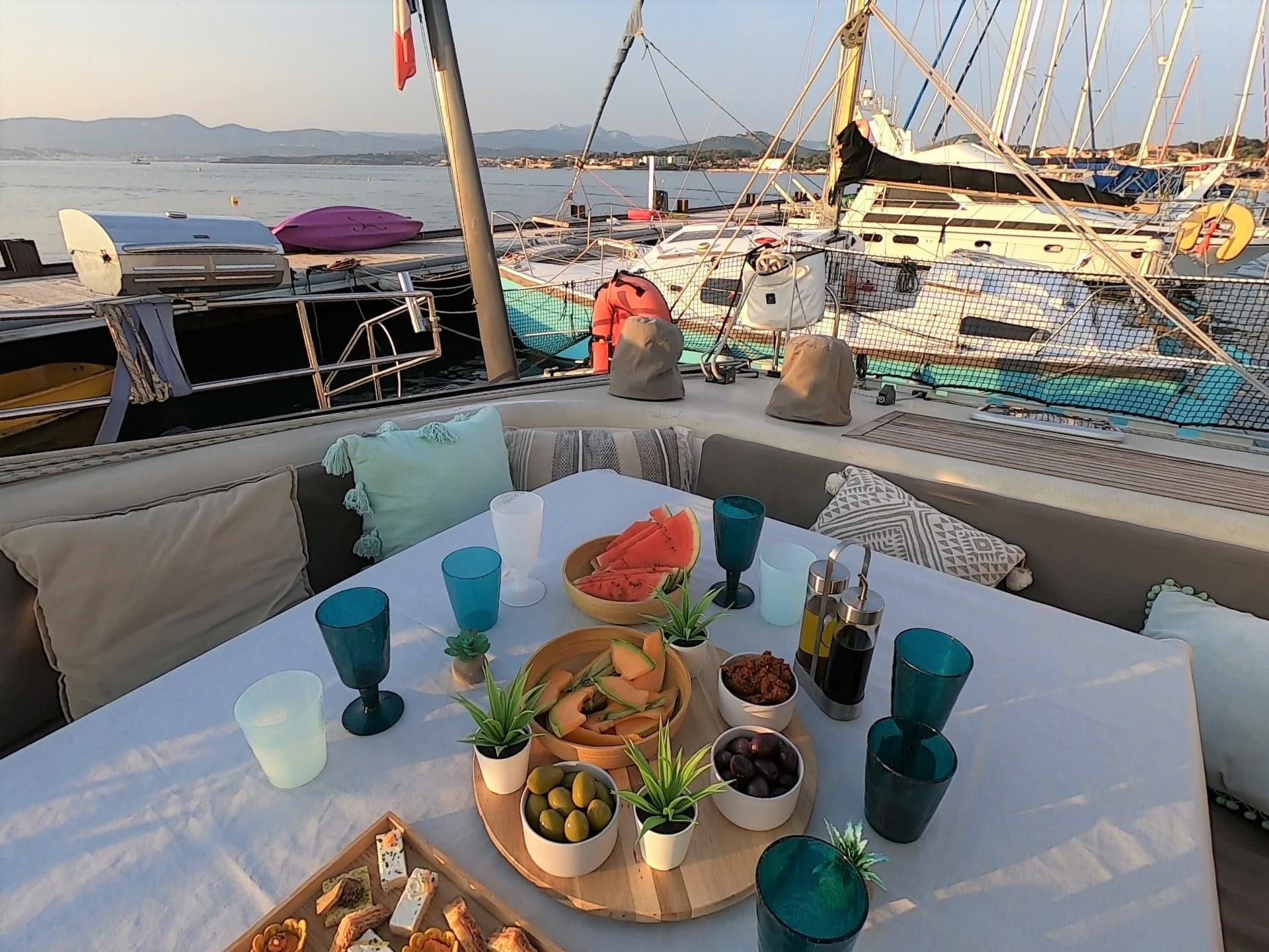 Yacht dining setup with snacks and drinks at marina dock