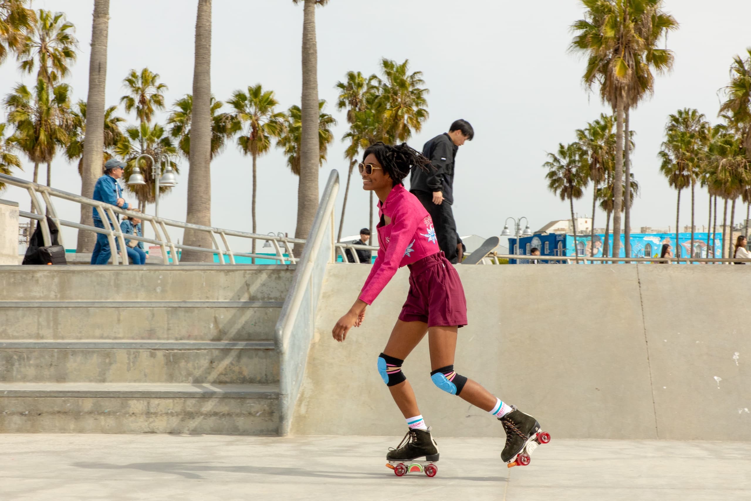 Roller skater cruising at outdoor Venice Beach skatepark