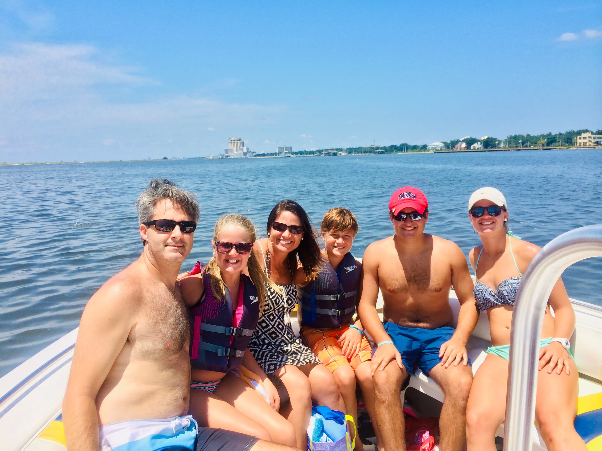 Friends on a charter boat enjoying sunny Gulf Coast bay excursion