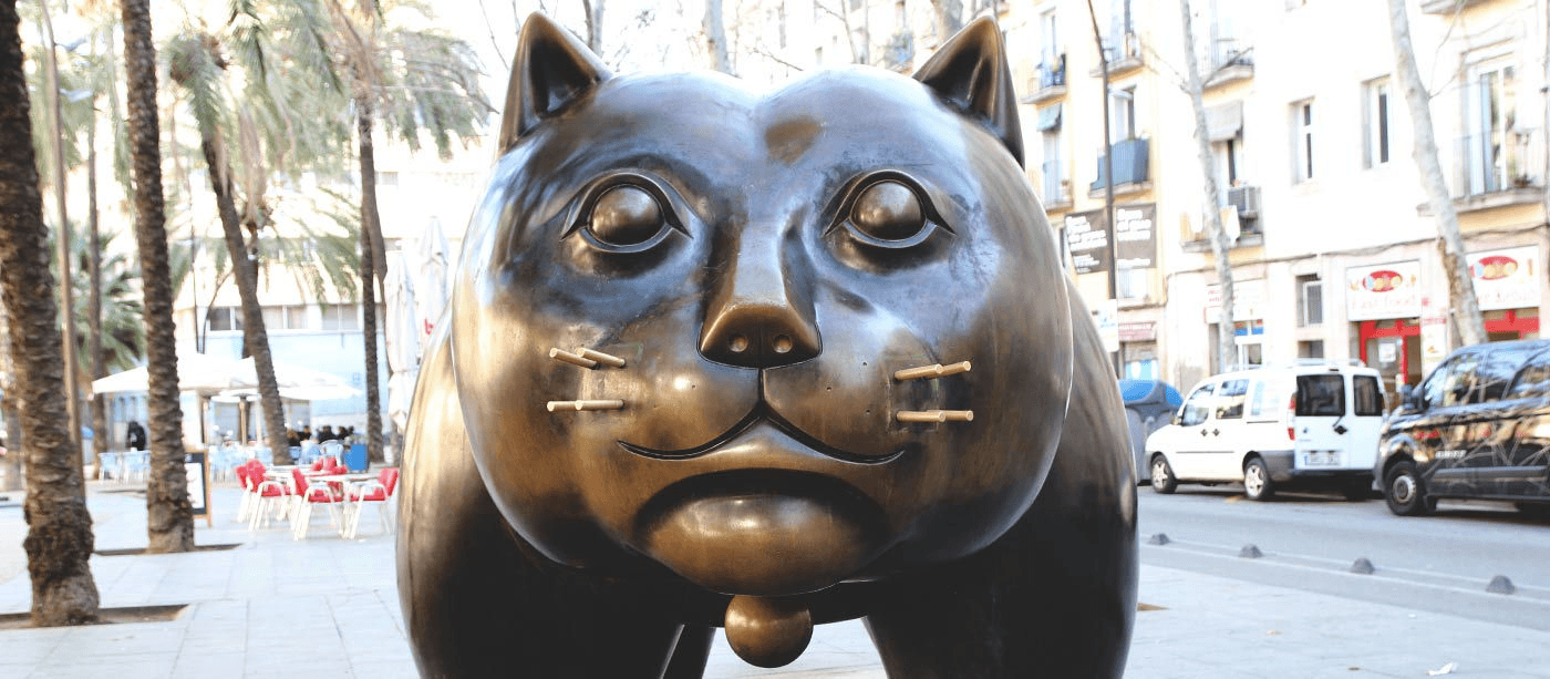 Bronze cat sculpture on Barcelona street showcasing urban art