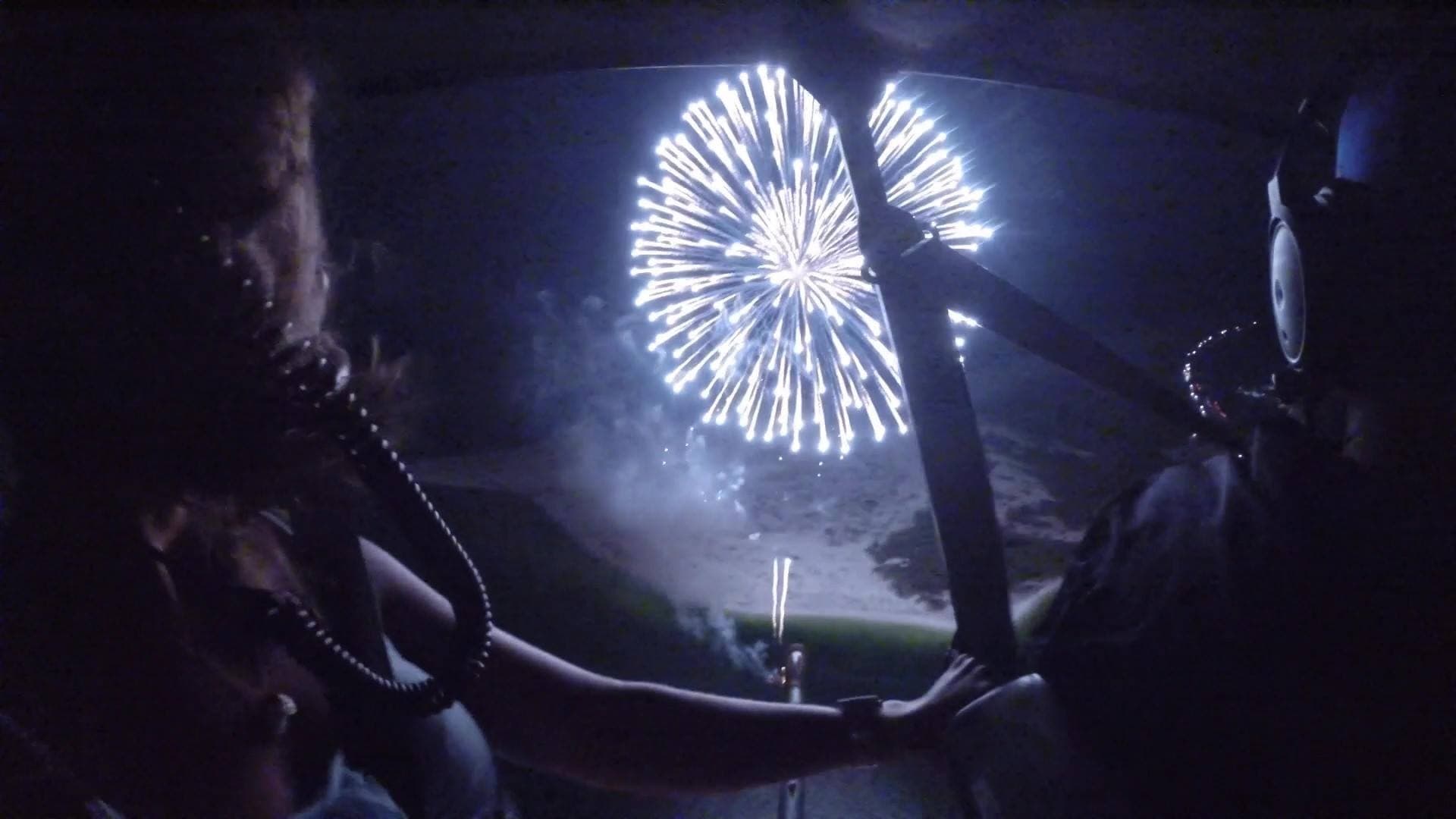 Night helicopter ride with fireworks over coastal beach viewing