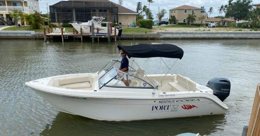 Center-console rental boat docking in Naples canal