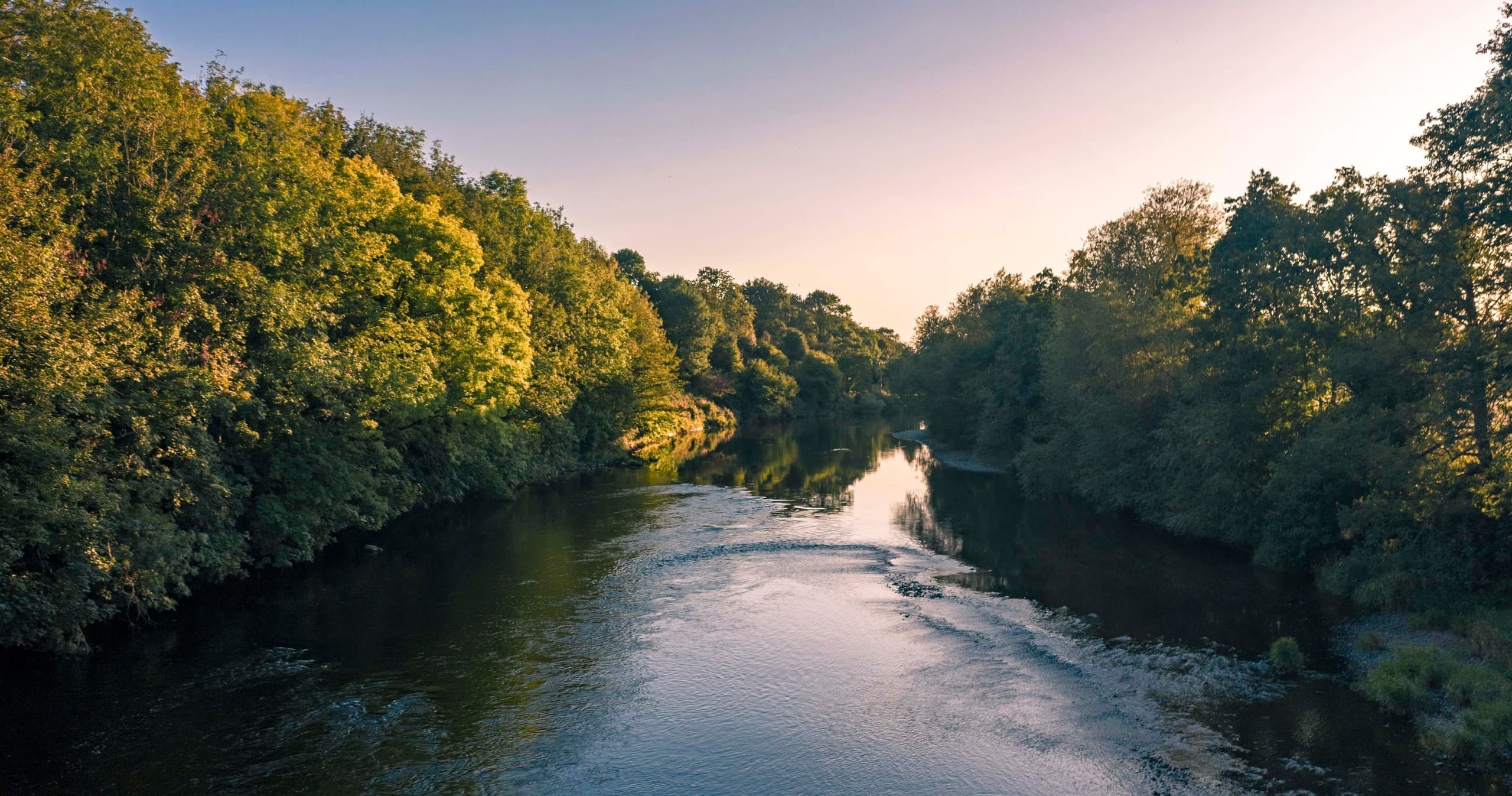 Sunset river panorama with calm water, scenic paddling route