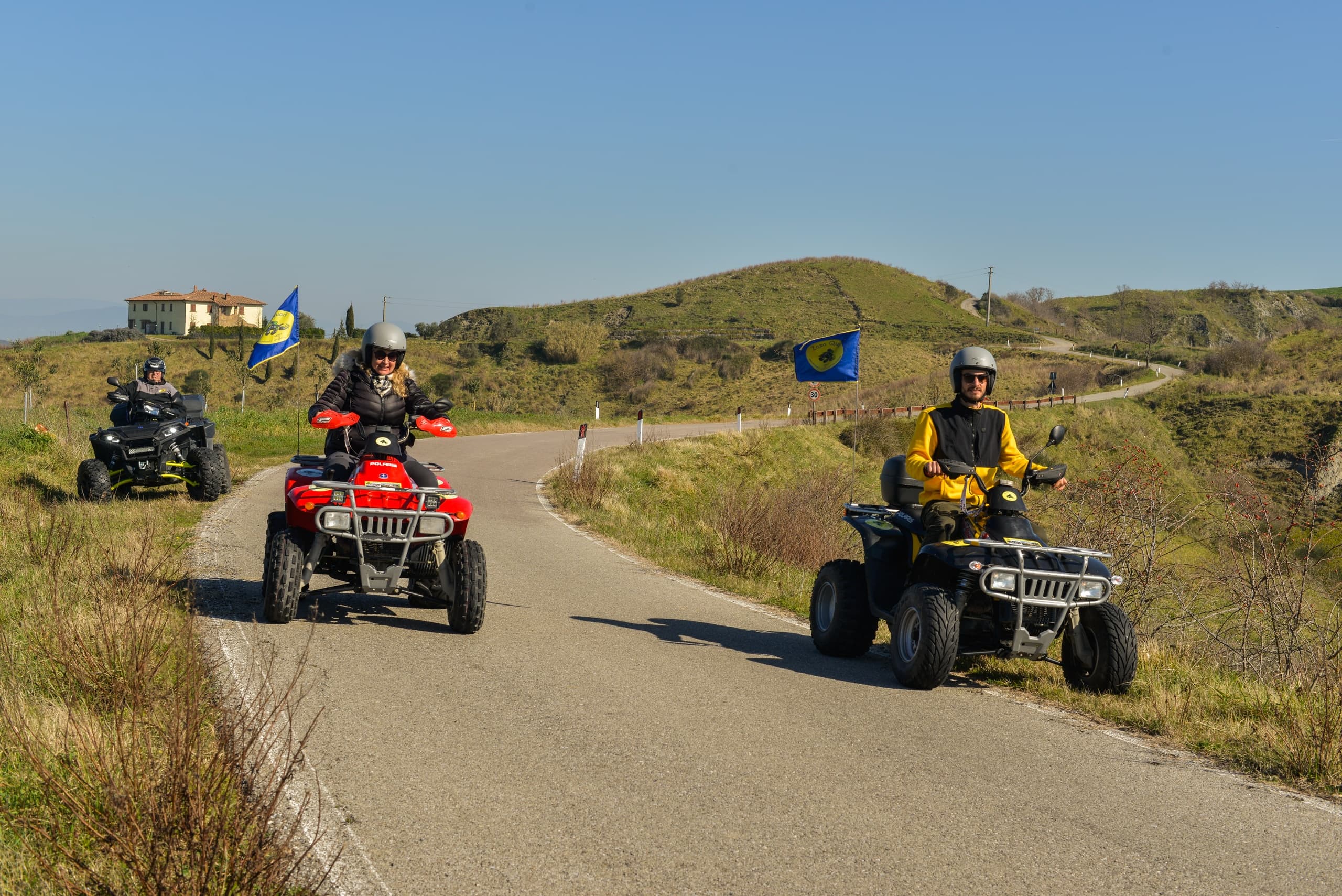 Off-road ATV riders exploring rural Tuscan trails