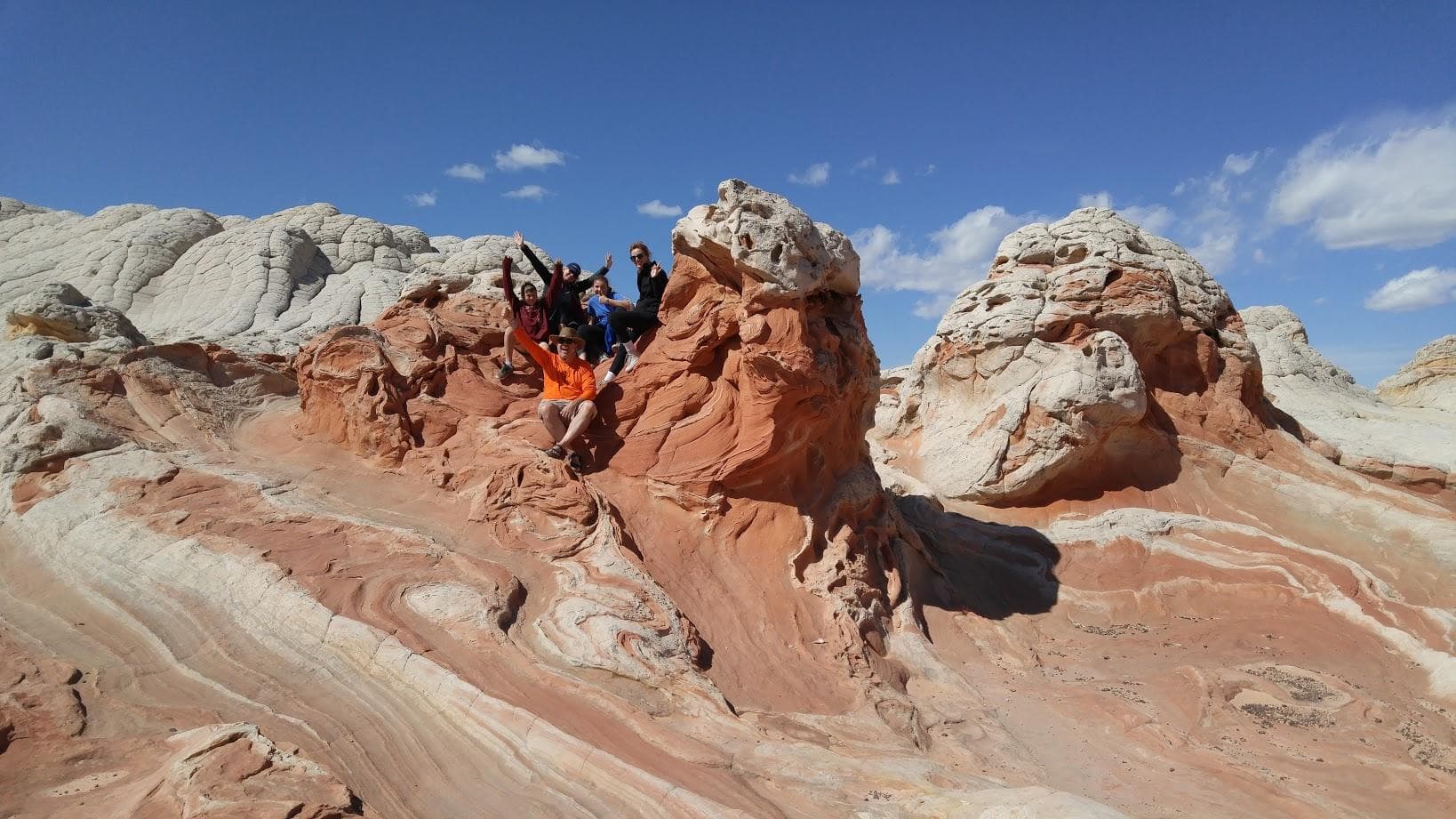Layered sandstone domes and swirling rock formations in desert