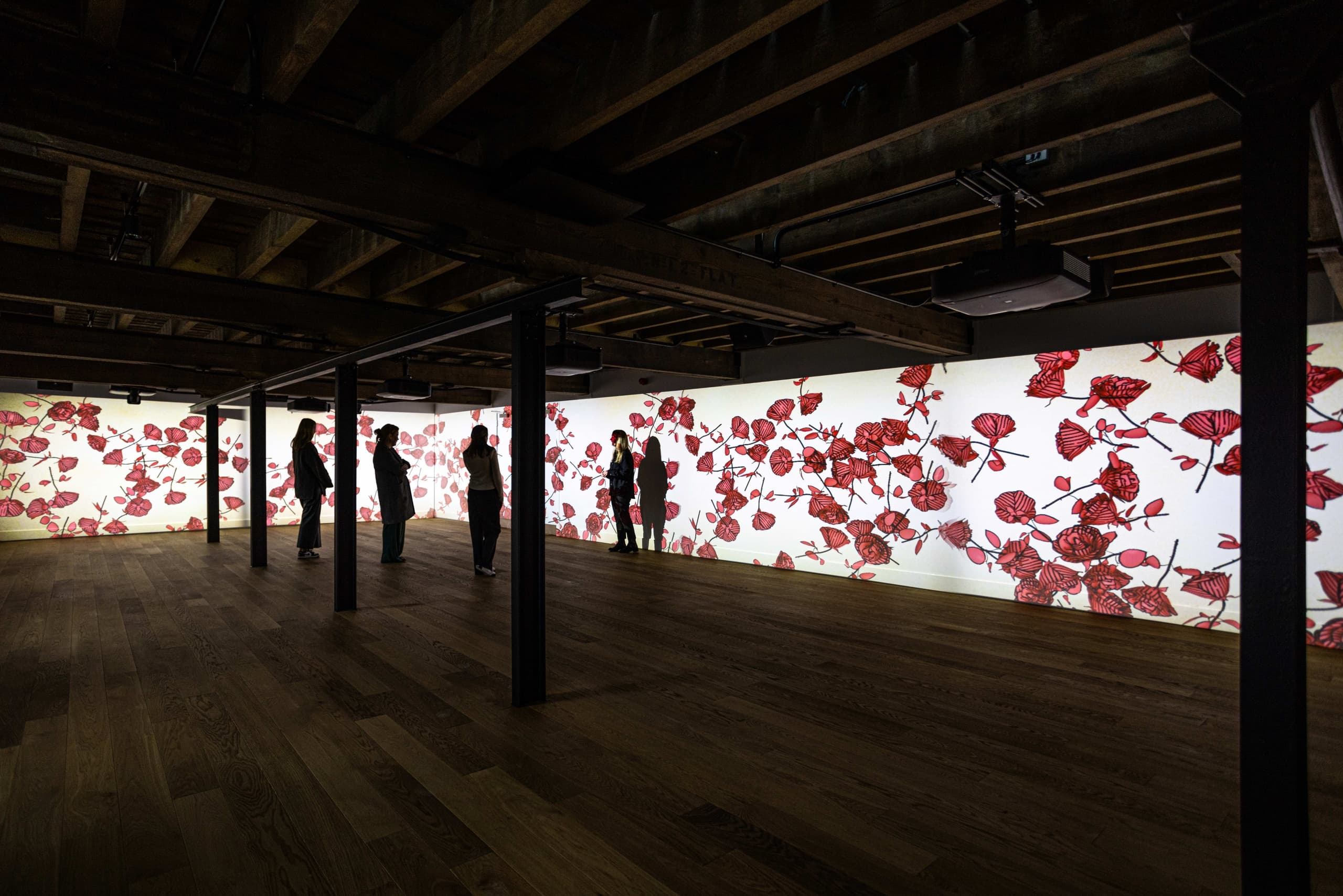 Visitors touring Rosebank Distillery tasting hall with floral mural