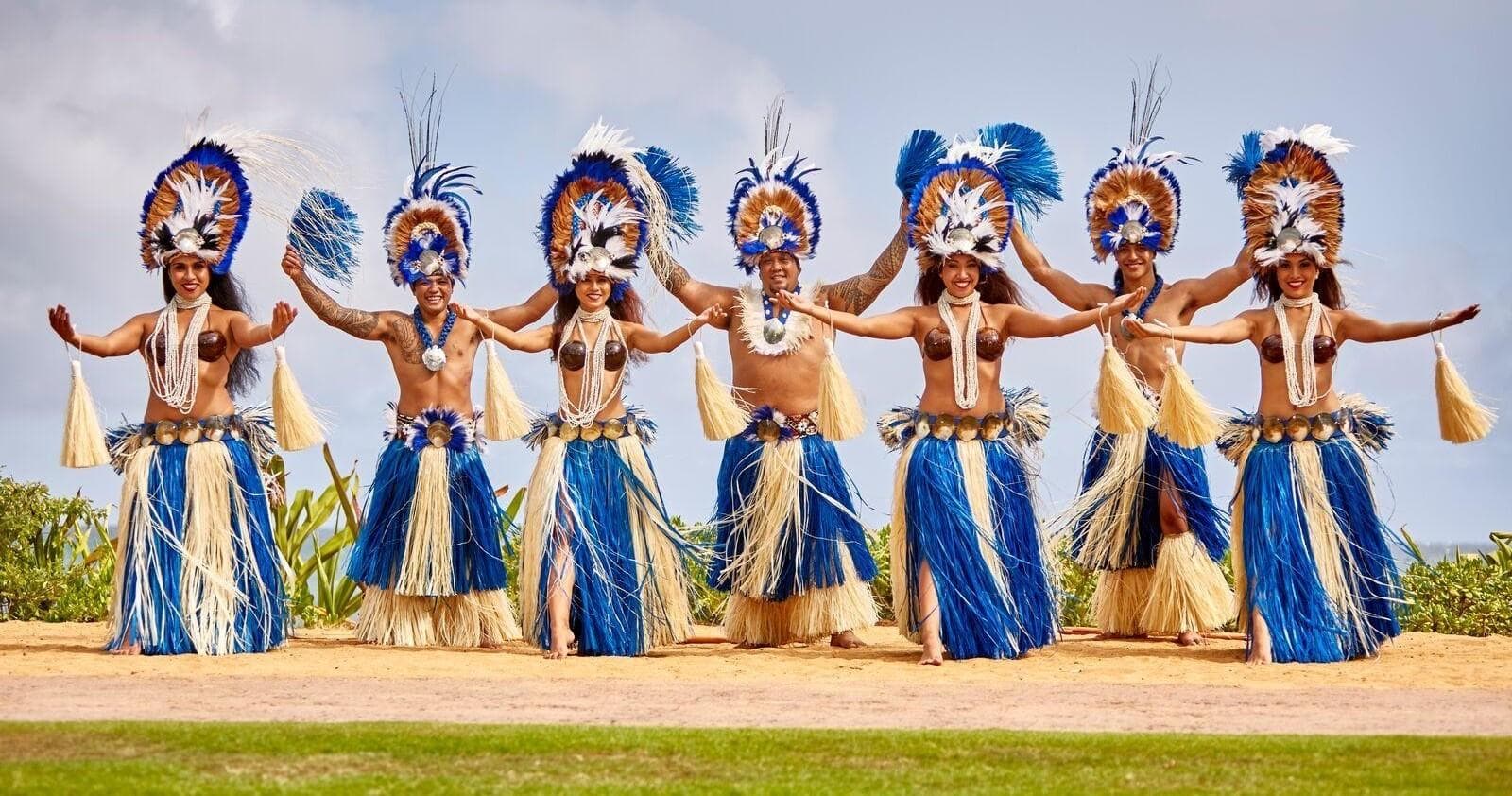 Tahitian dancers performing on coastal lawn at Hawaiian luau