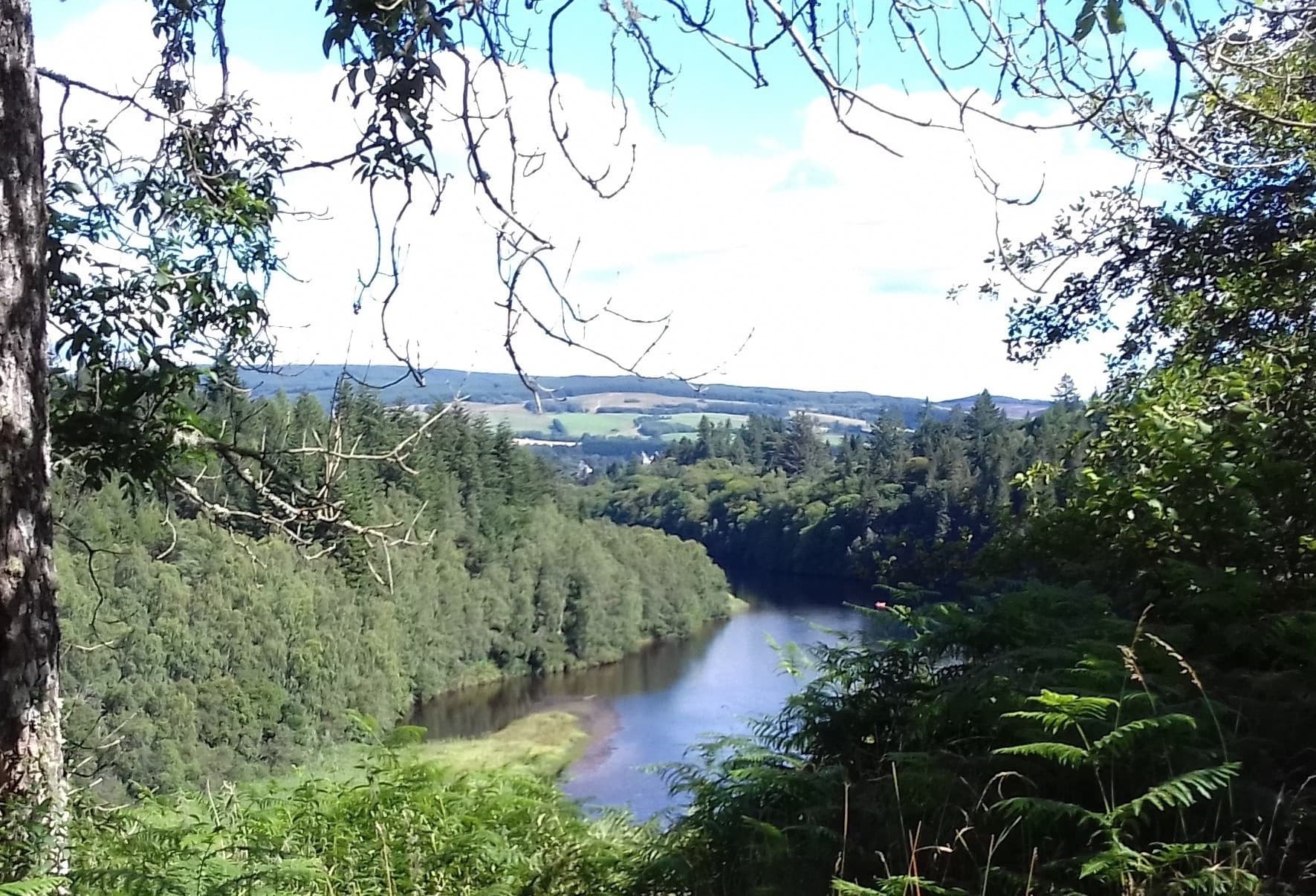 Scenic river overlook framed by trees on Highlands cycling trail