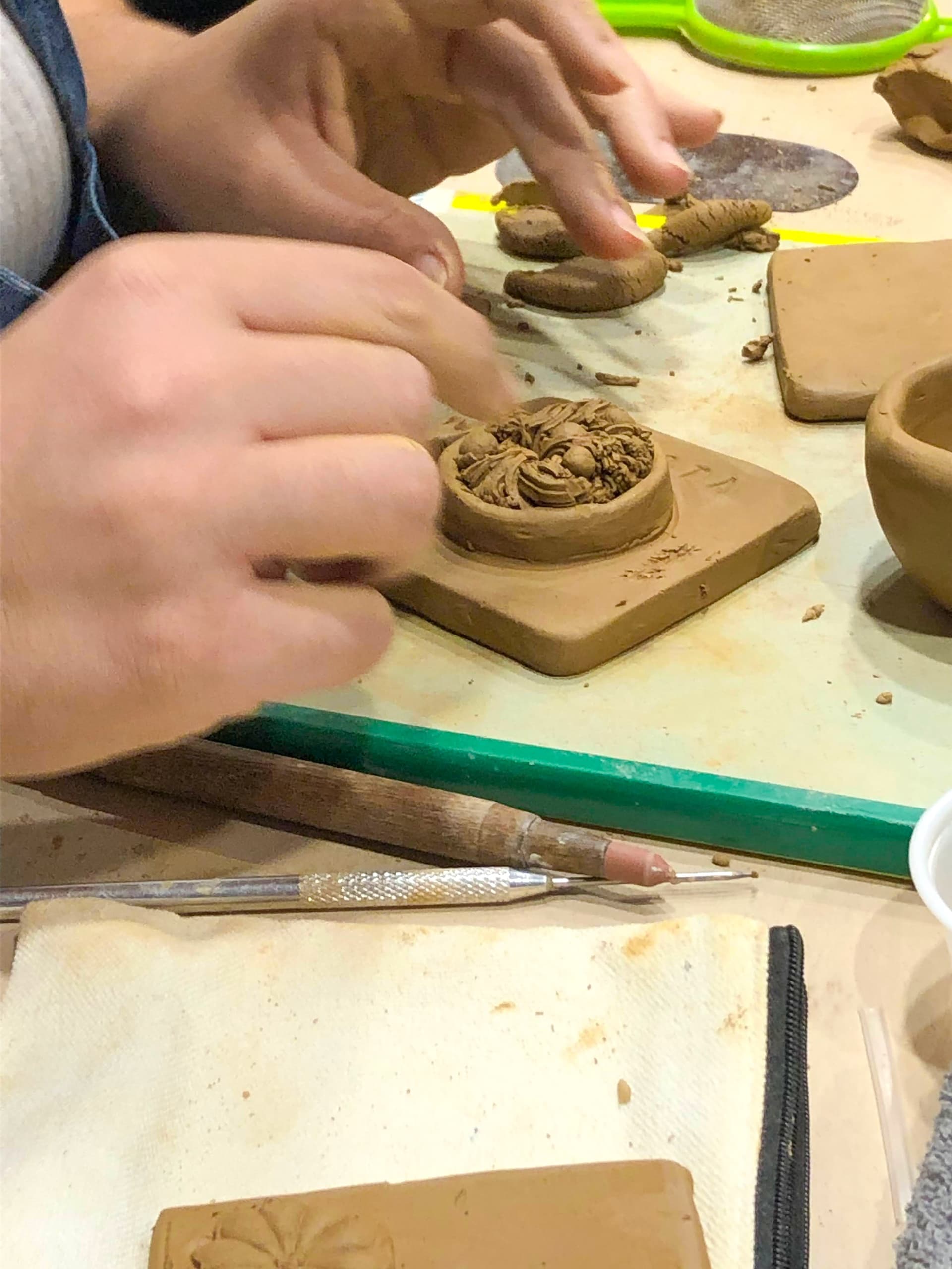 Close-up of ceramic tile painting in an indoor pottery studio